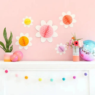 Create a whimsical pom pom garland with glitter paper and Kailo Chic's Honeycomb Daisies For Spring and Easter. Perfect for wall mounting.