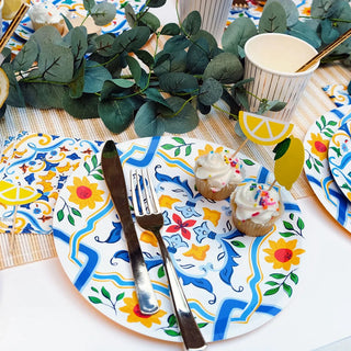 A table setting with Lemon Mini Toppers plates and napkins, featuring green glitter accents by Coterie Party Supplies.