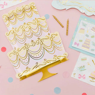A pink and gold birthday party kit with gold foil Let Them Eat Cake Large Napkins and tea party decorations from Daydream Society.
