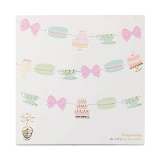 A white card featuring a Let Them Eat Cake Thingamajigs cake and bows as party decorations from Daydream Society.