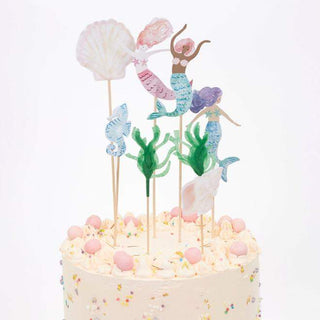 Mermaid Cake ToppersTurn a celebratory cake into something really special with these magnificent toppers. They feature beautifully illustrated mermaids, shells and a seahorse, and seaweMeri Meri