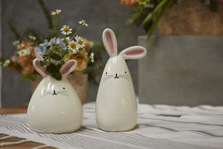 Two whimsical MINI BUNNY BUDVASE budvases from Accent Decor with hand-painted details on a table.