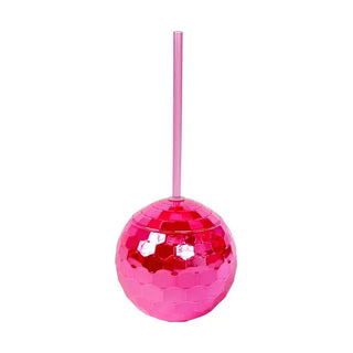 A group of Disco Drink - Hot Pink disco balls on a table at a Packed Party.