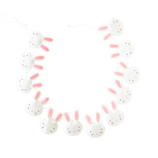 A charming easter-themed garland featuring sewn felt decorations of white bunny heads with cute, pink ears and whisker details, artfully arranged in a circular shape against a pure white background called the Puffy Felt Bunny Banner from My Mind's Eye.