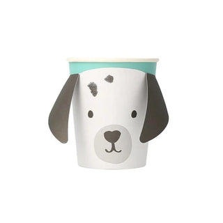 A charming white flowerpot with a Puppy Face with Droopy Ears Cups design by Meri Meri, featuring long droopy ears and playful grey spots, complete with a mint green rim, made from sustainable FSC paper.
