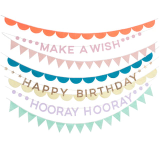 An eco-friendly Rainbow Birthday Garlands with the words "make a wish happy birthday" from Meri Meri.