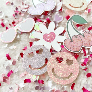 Retro Love ConfettiThe Mini Size Bags of this Retro Love Confetti Mix includes:• 1 /4 cup of confetti in pink, lavender and white• 11 cutouts including 3 sets of cherries, 3 daisies, 3Festive Fetti