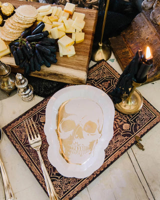 SKULL SHAPED 8in PAPER PLATESCreate a frightfully delightful tablescape starting with these shaped skull plates. Eerie gold foil accents add the perfect amount of spook to a halloween gathering.My Mind’s Eye
