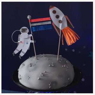 Space Cake ToppersTurn a space cake into something really sensational with this topper set. It features a spaceman holding a colorful flag, and a rocket blasting off to the skies.

ShMeri Meri