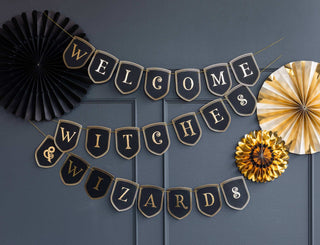 SpellboundElevate your Halloween party decor with a Spellbound Welcome Witches &amp; Wizards Banner! This cardstock welcome sign features black pennants with gold foil lettersMy Mind’s Eye