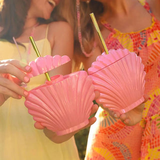 Two women enjoying their beach trip while holding Packed Party's Shell-ebrate Sipper with straws.