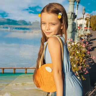 Clementine BasketThis deliciously juicy basket bag is a fun way to carry your everyday essentials! With a sweet yellow gingham lining, shoulder length leatherette gold straps and magRockahula Kids