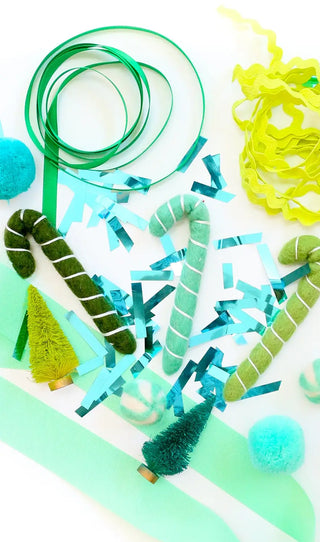Green Blue Gift Topper Kit
Bag of ribbon, trim, confetti, and gift topper shapes such as trees, candy canes, honeycomb balls, Pom Poms, etc… all in a green and blue color palette.Kailo Chic